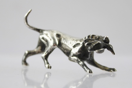 PETER JOHN DOHERTY SILVER LTD. A CAST SILVER MODEL OF A HOUND with a game bird in it's jaw,