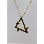 A 9CT GOLD MODERN PENDANT fashioned as an Isosceles triangle on which is mounted three equilateral