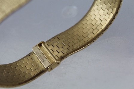 A LADY'S "BUECHE GIROD" 9CT GOLD INTEGRAL BRACELET WATCH, having bark textured bracelet, a bezel - Image 4 of 4