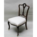 A LATE 19TH CENTURY MAHOGANY LOW SEATED CHAIR with fancy carved and pierced central slat back, on