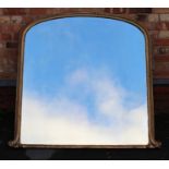 A 19TH CENTURY GILT FRAMED OVERMANTEL MIRROR having scroll terminals to the lower frame, plate