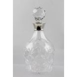 E**S**C** AN ENGLISH CUT LEAD CRYSTAL PORT WINE DECANTER with applied spun silver collar, Birmingham