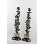 A PAIR OF EARLY 20TH CENTURY CANDLESTICKS the stems of figural cast spelter in the form of Art