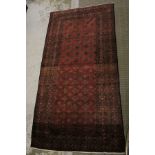 AN ANTIQUE NOMADIC TRIBE HAND-WOVEN CARPET, having allover typical geometric pattern with