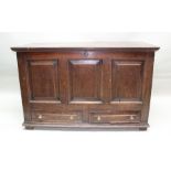 A GEORGE III OAK MULE CHEST having hinged cover over triple panel front fitted two drawers below,