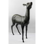 A PATINATED BRONZE STATUE OF A DEER, standing 58cm high