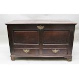 AN EARLY 18TH CENTURY OAK MULE CHEST having hinged cover, panelled front fitted two drawers to base,