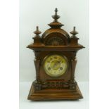 A 20TH CENTURY JUNGHANS WALNUT FINISHED MANTEL CLOCK having carved and moulded case with knops and