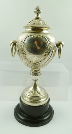 JAMES DEAKIN AND SONS A LATE VICTORIAN SILVER TROPHY CUP of globular form with ring handles, on a