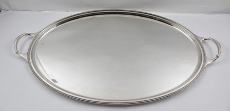 A "ROMNEY" SHEFFIELD SILVER PLATED OVAL TEA TRAY with beaded edge, fitted two carrying handles, tray