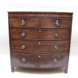 A 19TH CENTURY MAHOGANY BOW FRONTED CHEST OF DRAWERS, having two short over three long graduated