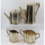 A LATE VICTORIAN FOUR PIECE SILVER PLATED COFFEE AND TEA SET comprising; coffee pot, tea pot, milk