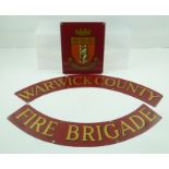 A THREE SECTION NAME PLATE FROM A FIRE ENGINE comprising two red ground crescents inscribed in