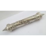 AN ORNATE PIERCED AND CHASED WHITE METAL PRAYER SCROLL HOLDER with onion dome type ends, 26cm long