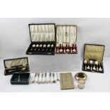 A QUANTITY OF ASSORTED CASED SILVER SPOONS, a silver napkin ring, white metal items etc.