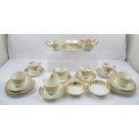 A QUANTITY OF NORITAKE CUPS AND SAUCERS, having gilded decoration on a white and cream ground,