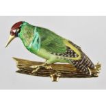 AN "ALABASTER & WILSON" 9CT GOLD AND ENAMELLED BROOCH in the form of a woodpecker upon a branch,