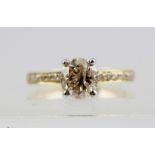 AN 18CT GOLD SOLITAIRE RING with diamond set shoulders, size M