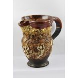 A ROYAL DOULTON STONEWARE WINE JUG with applied fruiting vine and revelling cherubs in the round,