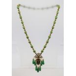 A PEKIN GLASS BEAD NECKLACE with Blackamoor mask pendant and droppers, screw clasp mounted