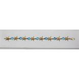 A 14CT GOLD STAR FISH & TOPAZ BRACELET each star interspersed with an oval faceted stone