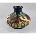 A LATE 20TH CENTURY MOORCROFT POTTERY VASE of squat form, having tube lined and hand painted Passion