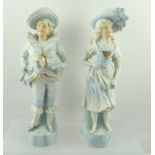 A PAIR OF LATE 19TH CENTURY CONTINENTAL BISQUE FIGURES, a boy and girl in gilded pale blue