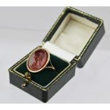 A 19TH CENTURY GOLD CARVED CARNELIAN INTAGLIO SEAL RING, depicting a profile head of a young woman