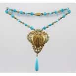 AN EGYPTIAN REVIVAL NECKLACE depicting Rudolph Valentino as a Pharaoh, with turquoise glass coloured