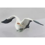 A LATE 20TH CENTURY LLADRO MODEL OF A STORK/HERON, seated with outstretched wings, decorated in