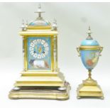 AN EARLY 20TH CENTURY GILT, BRASS AND PORCELAIN PANELLED FRENCH GARNITURE comprising a clock with