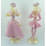 A PAIR OF MURANO GLASS FIGURINES in 18th century costume, pink and clear with aventurine highlights,