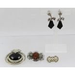 A COLLECTION OF ART DECO JEWELLERY comprising; a dress clip, two brooches and a pair of black onyx