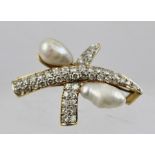 AN 18CT GOLD SET BROOCH, designed as two intersecting crescents of diamonds with two Baroque pearls,