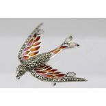 A SILVER, MARCASITE AND OPAL SET BIRD BROOCH fashioned in flight, having coloured translucent