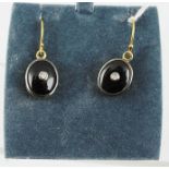 A PAIR OF ONYX AND DIAMOND EARRINGS