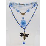 A BLUE GLASS NECKLACE with pendant drop, together with a BLUE ENAMELLED DRAGONFLY AND BEAD NECKLACE