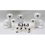 THREE PAIRS OF VICTORIAN STAFFORDSHIRE POTTERY MANTEL DOGS, largest 24cm high, with gilded chains,
