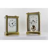 A LATE 19TH CENTURY BRASS FRAMED CARRIAGE TIMEPIECE with bevel glass panel insert, white enamel dial
