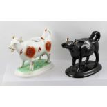 A VICTORIAN BLACK JACKFIELD GLAZED TERRACOTTA COW CREAMER with cover, on raised oval base,