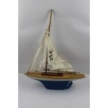 AN "UFFA FOX" POND YACHT, having blue and white hull, with mast and sails, 39cm long, in original