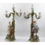 A PAIR OF LATE 19TH CENTURY SITZENDORF PORCELAIN FIGURAL CANDELABRAS, the floral encrusted bases and