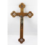 A CONTINENTAL CRUCIFIX, the oak cross mounted with a bronzed metal depiction of Christ, 70cm high