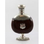 A CONTINENTAL WHITE METAL MOUNTED NUT SCENT BOTTLE with hinged cover, blind shield cartouche, raised