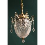 A PAIR OF REGENCY DESIGN BRASS AND CUT GLASS CEILING LIGHTS, fluted knop brass rods come down to a