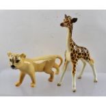 A BESWICK EARTHENWARE FIGURE OF A GIRAFFE, 19cm high, and a LION CUB, 10cm high