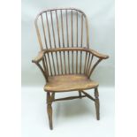 A 19TH CENTURY ELM SPINDLE BACK COUNTRY KITCHEN CHAIR having shaped arms and sculpted seat on turned