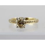 AN 18CT GOLD DIAMOND SOLITAIRE RING, with diamond set shoulders on plain shank, stamped "750",