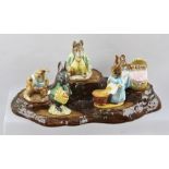 A BESWICK EARTHENWARE TREE STUMP BASE WITH FIVE BEATRIX POTTER FIGURES, to include "Little Black