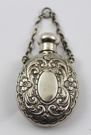 GEORGE UNITE A SILVER SCENT FLASK of oval form with screw cap and chain handle, embossed floral - Image 4 of 4